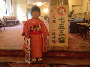 A girl is posing for photo of visiting a shrine for Shichi-go-san