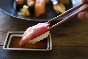 Eat sushi using chopsticks